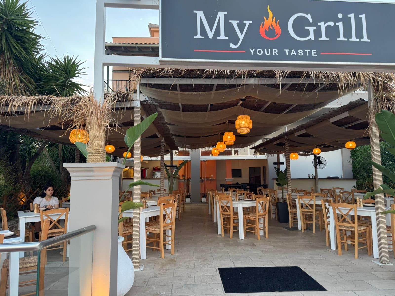 The lit entrance of MyGrill Steakhouse at dusk